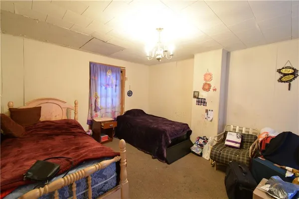 a bedroom with furniture and a chandelier