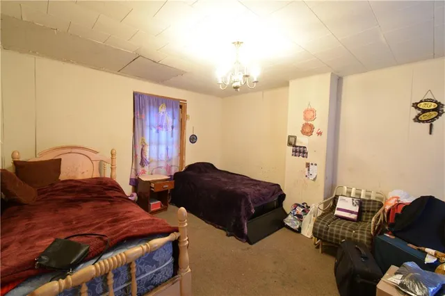 a bedroom with furniture and a chandelier