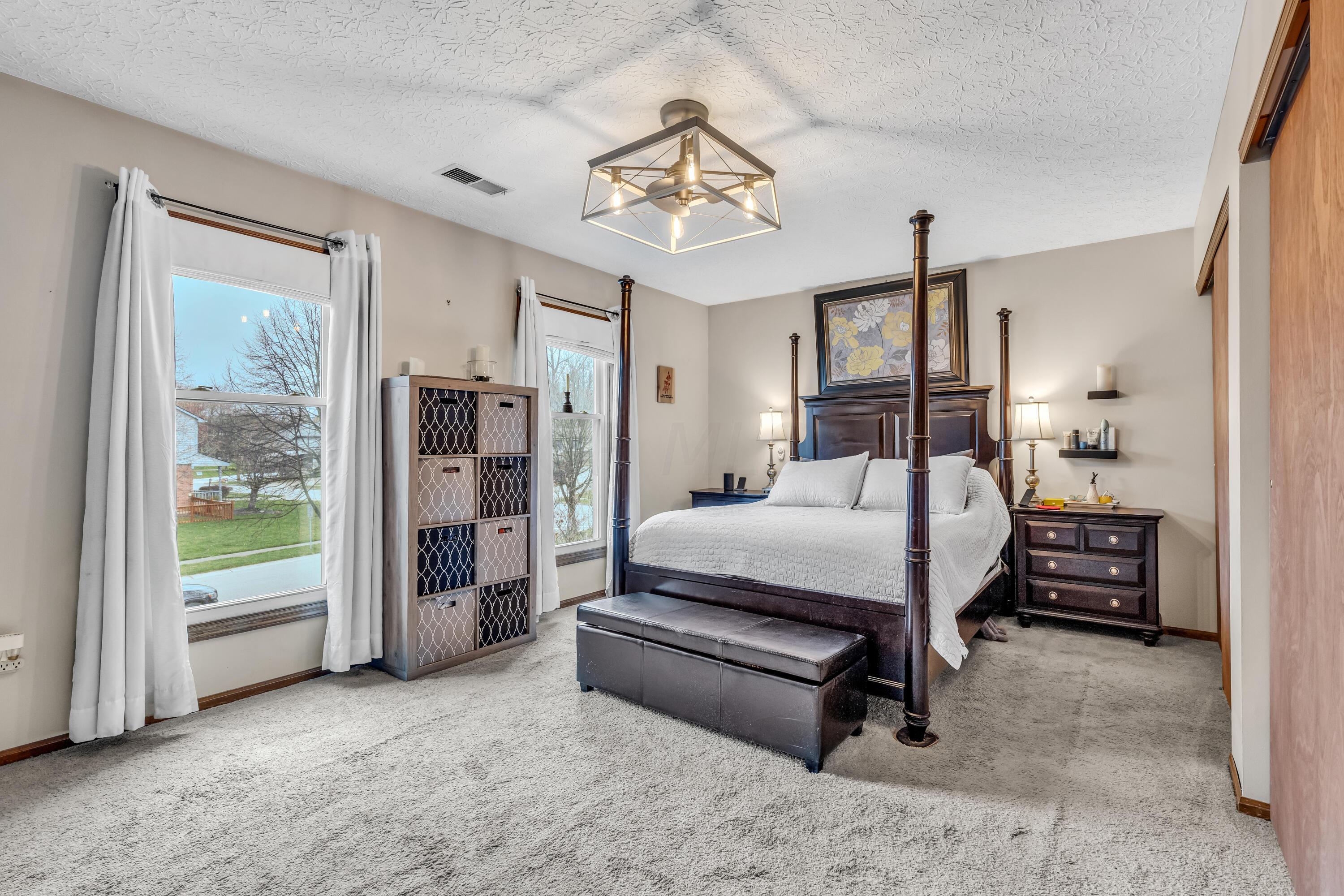 435 Emory Street Gahanna, OH 43230 - Photo 26 of 54 • Light sand carpet
• Tan painted walls
• New lighted ceiling
fan ~ 2023
• His & Her Closets with
double sliding doors
(one with attic access)
• Drapes and shades remain
• Wall shelves are negotiable