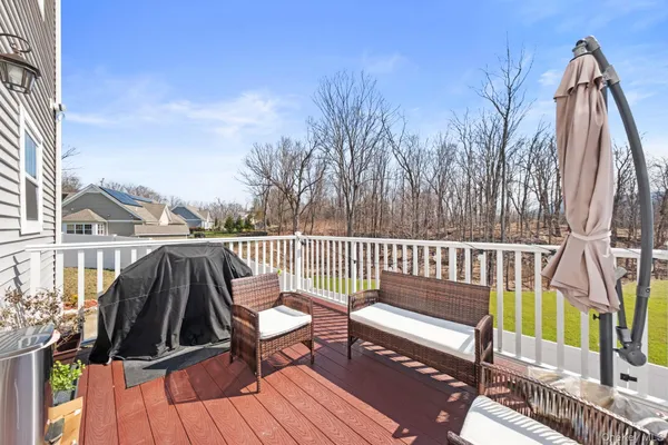 a view of balcony with wooden floor and outdoor seating