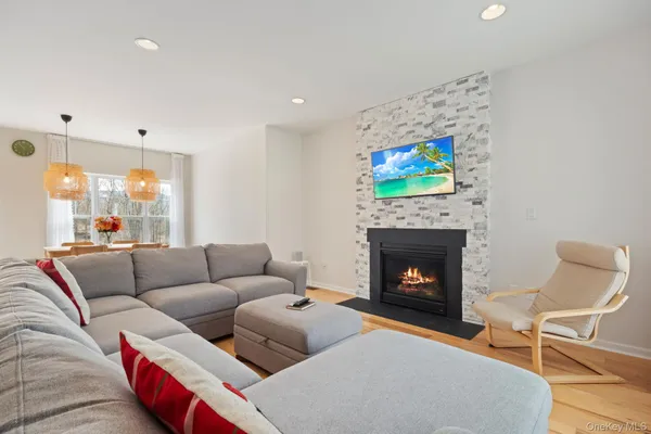 a living room with furniture a fireplace and a flat screen tv