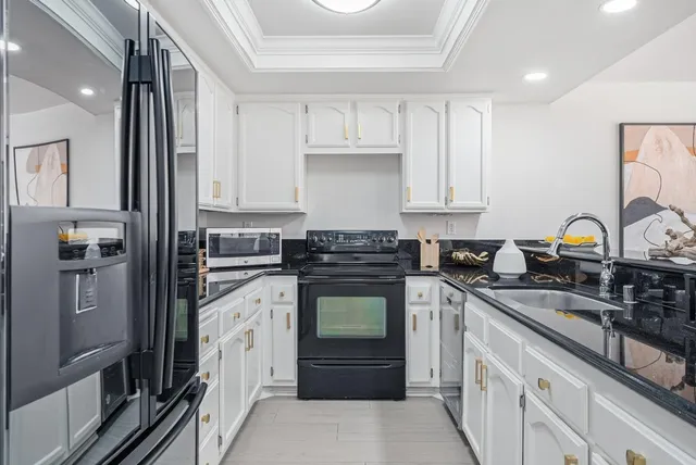 a kitchen with a refrigerator stove and sink