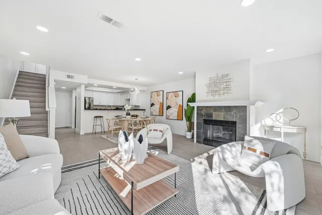 a living room with furniture and a fireplace