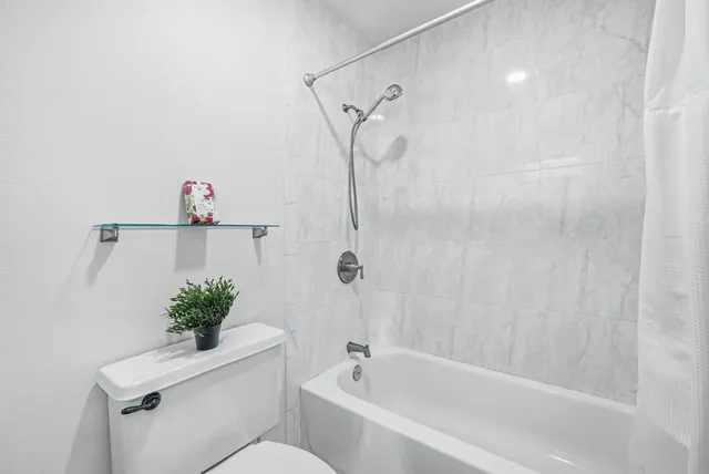 a spacious bedroom with a bed and a couch