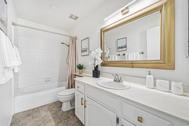 a view of a couches in the patio with a small yard