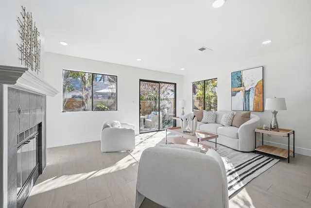 a living room with furniture large window and lamp