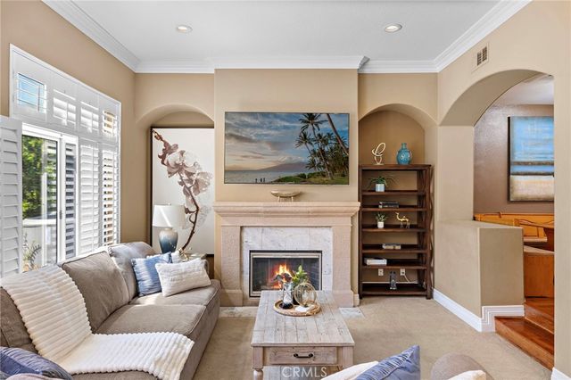 a living room with furniture a fireplace and a large window