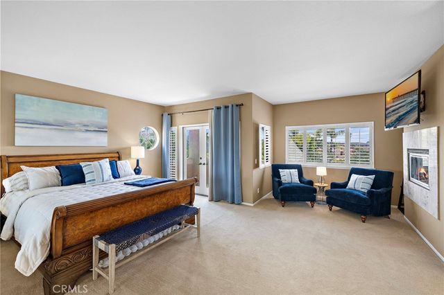 a spacious bedroom with a bed and glass windows