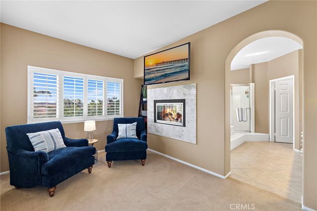 a spacious bathroom with a tub sink and mirror