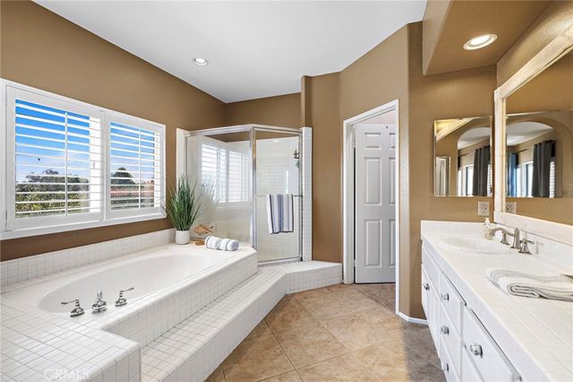 a spacious bathroom with a double vanity sink mirror and double