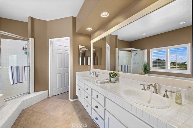 a spacious bathroom with sink shower and bathtub