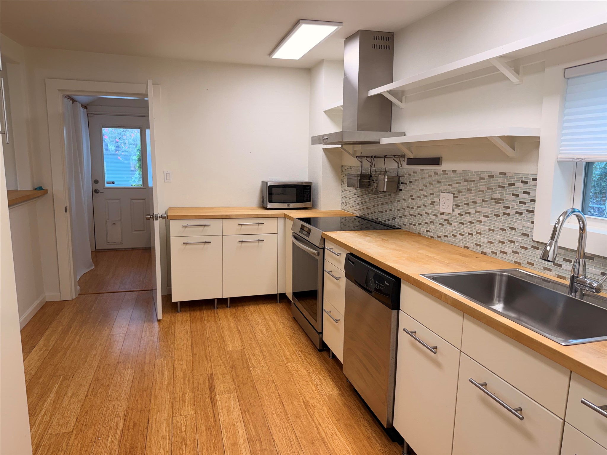 1182 Pandora Street Austin, TX 78702 - Photo 8 of 19 A streamlined kitchen provides ample workspace, modern appliances, and a convenient exterior door.