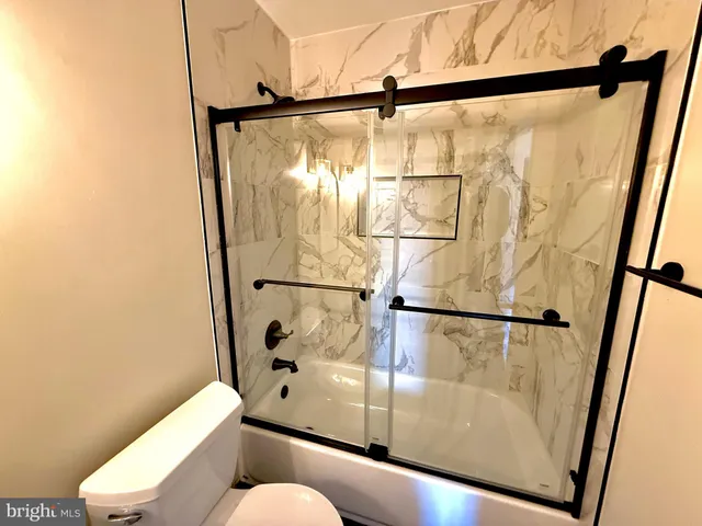 a bathroom with a shower and a mirror