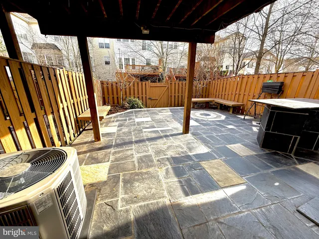 a view of a porch with wooden floor and door