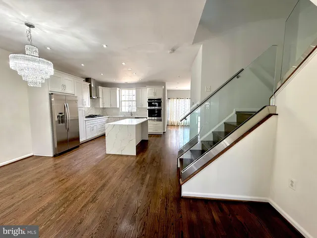 a view of a kitchen with furniture and wooden floor
