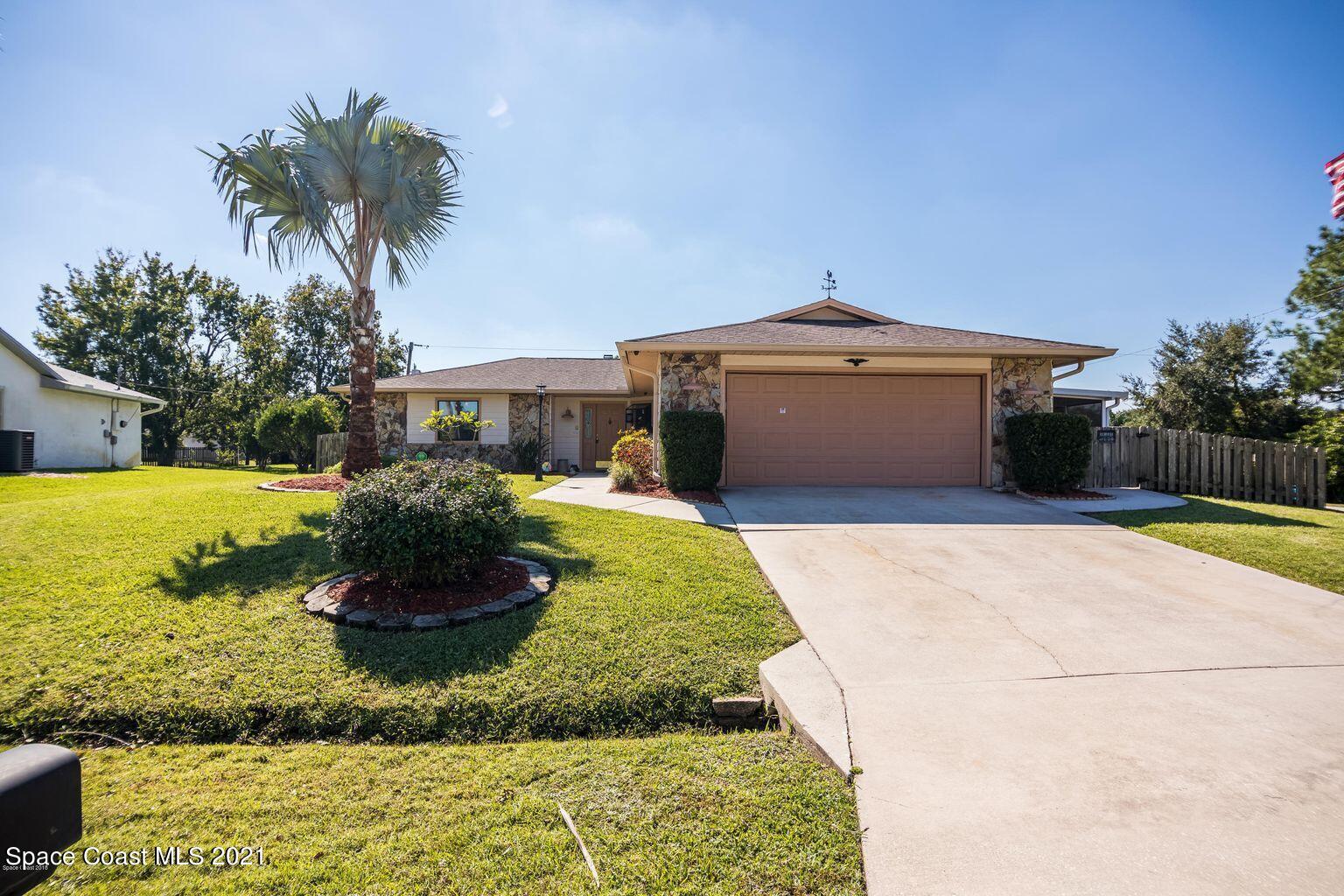 376 Trier Road Northwest Palm Bay, FL 32907 - Photo 1 of 16 a view of a house with a yard and a garden
