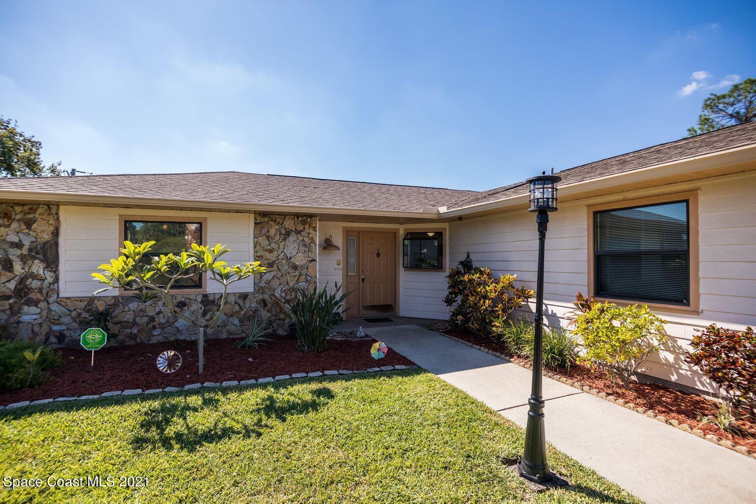 376 Trier Road Northwest Palm Bay, FL 32907 - Photo 2 of 16 a front view of a house having yard