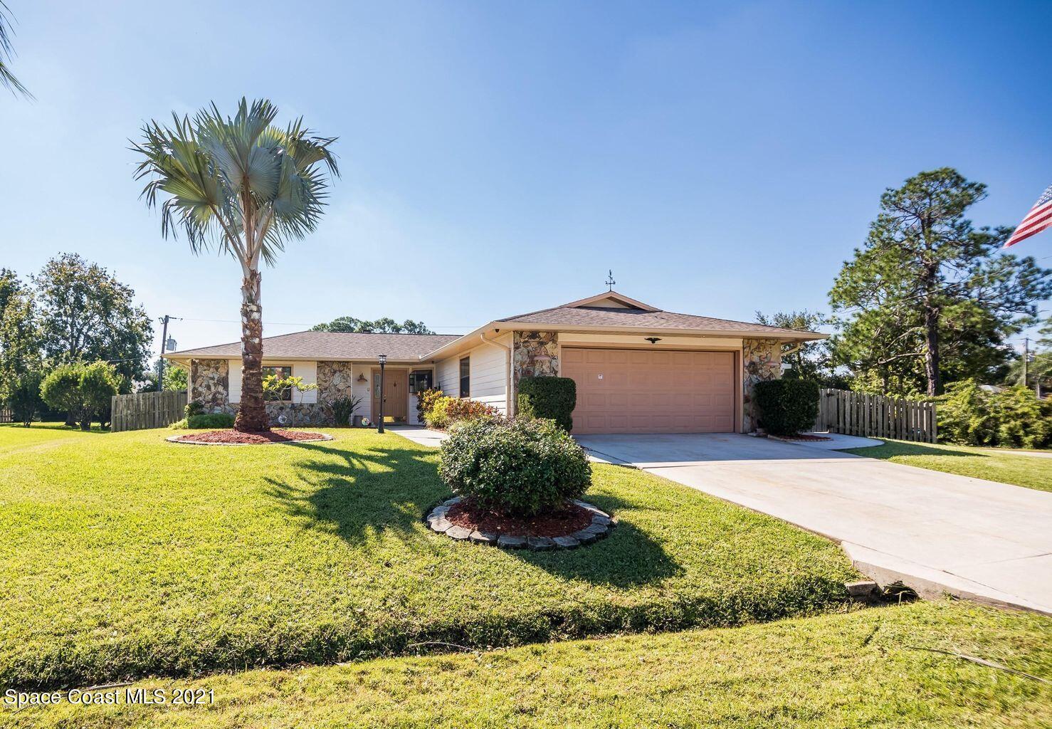 376 Trier Road Northwest Palm Bay, FL 32907 - Photo 14 of 16 a front view of a house with yard and garage