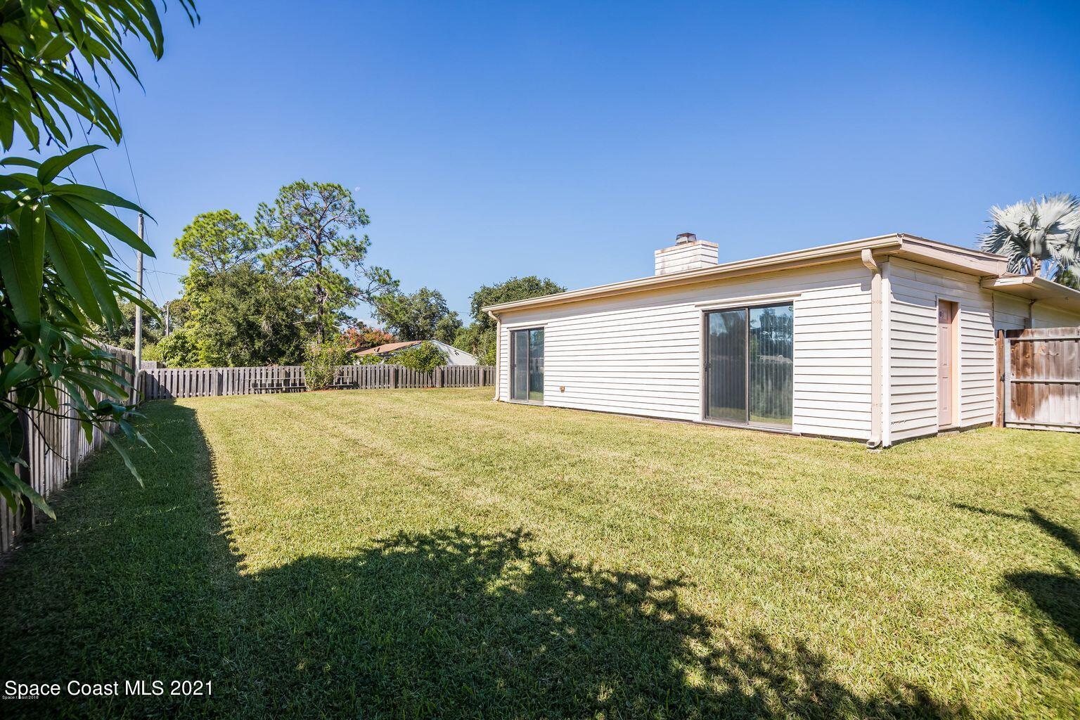376 Trier Road Northwest Palm Bay, FL 32907 - Photo 16 of 16 a view of a house with a yard