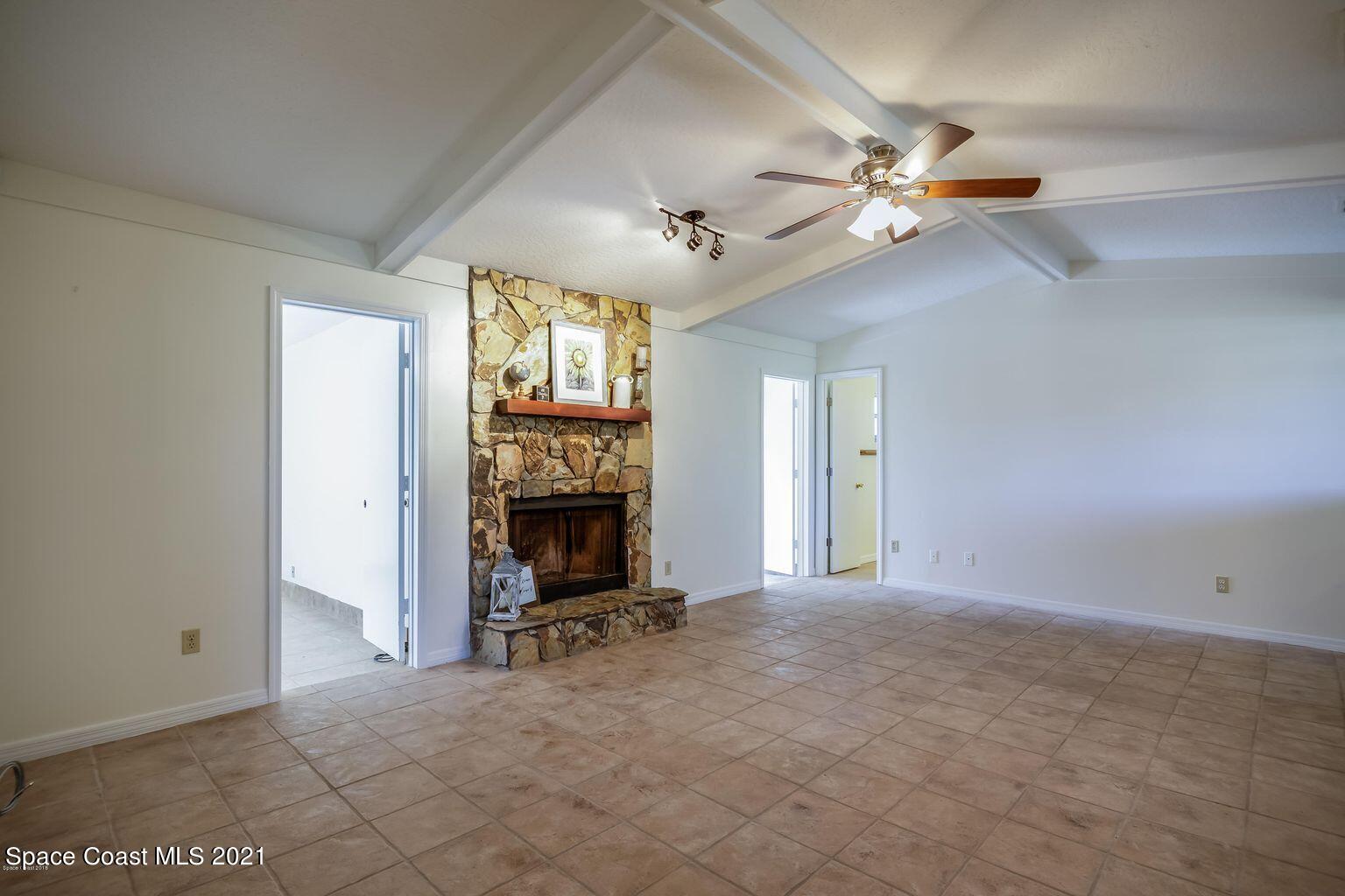 376 Trier Road Northwest Palm Bay, FL 32907 - Photo 5 of 16 a view of a livingroom with a fireplace and a window
