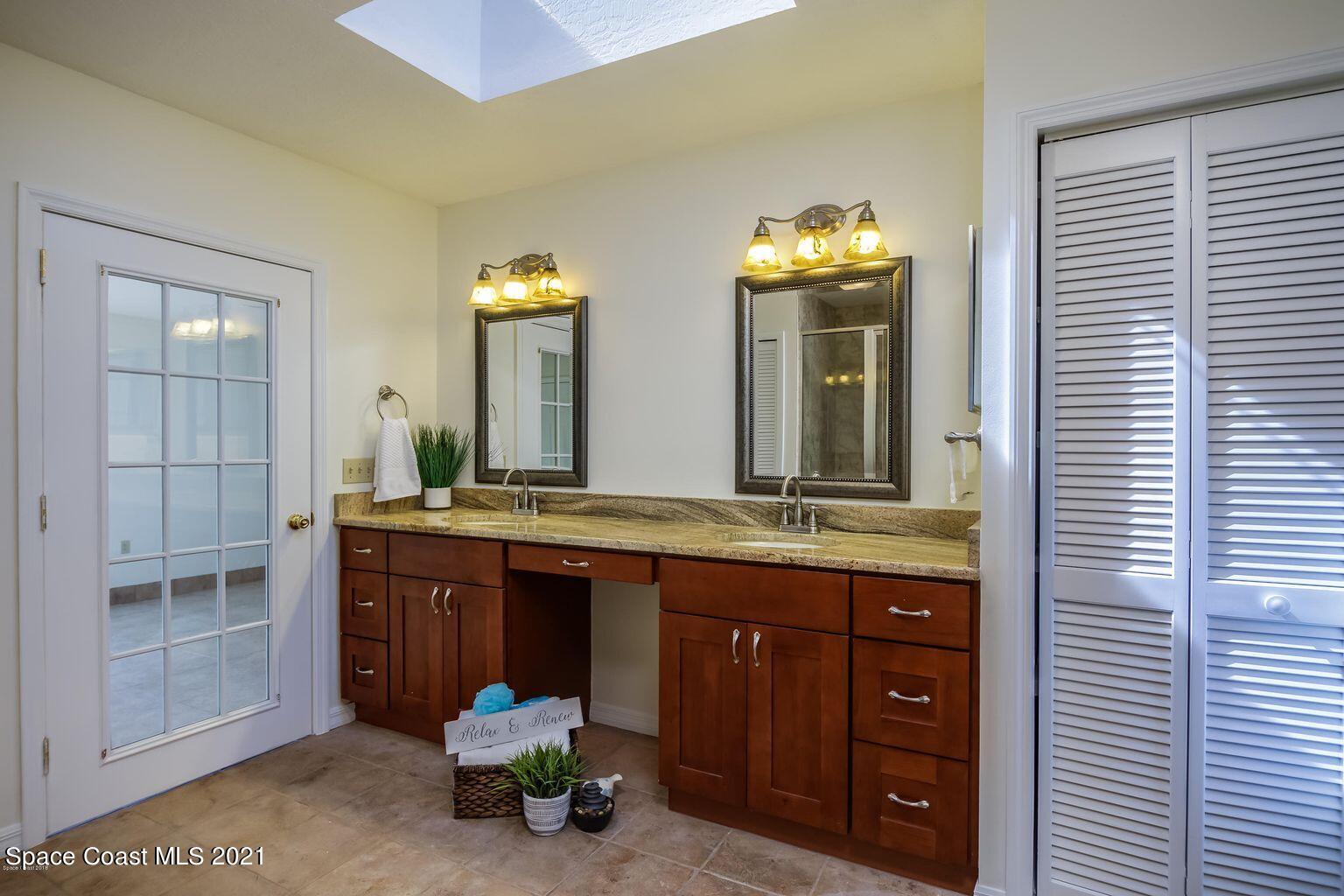 376 Trier Road Northwest Palm Bay, FL 32907 - Photo 6 of 16 a spacious bathroom with a granite countertop sink and a mirror