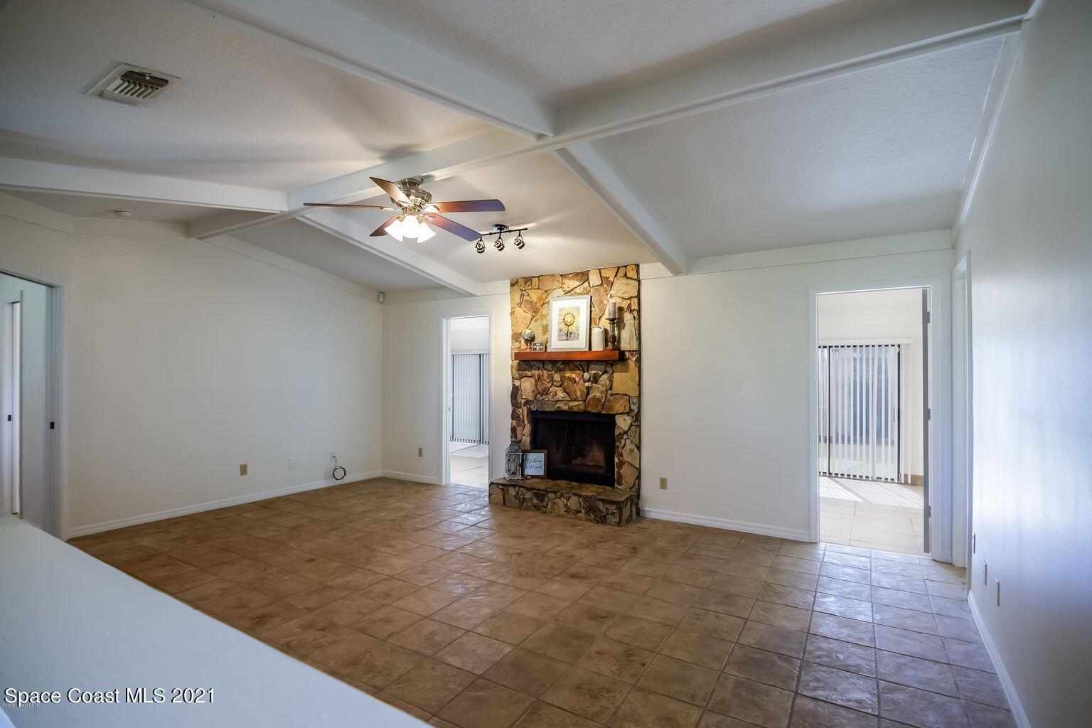 376 Trier Road Northwest Palm Bay, FL 32907 - Photo 9 of 16 wooden floor in an empty room with a fireplace