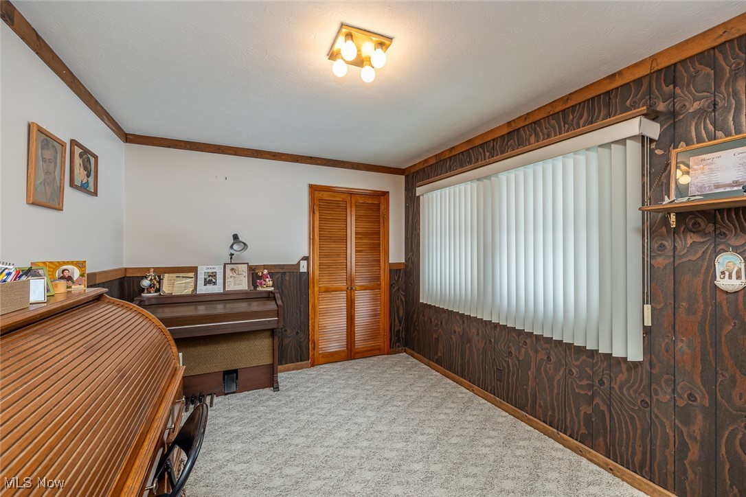 750 Sagamore Road Northfield, OH 44067 - Photo 27 of 37 Bedroom 4 with a closet, crown molding, and paneled walls