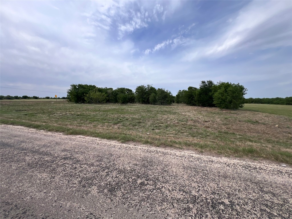 a view of a field with next to a lake
