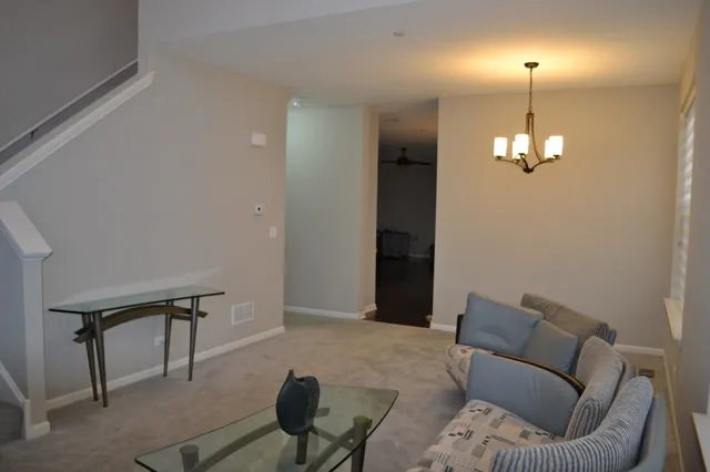 a living room with furniture and a chandelier