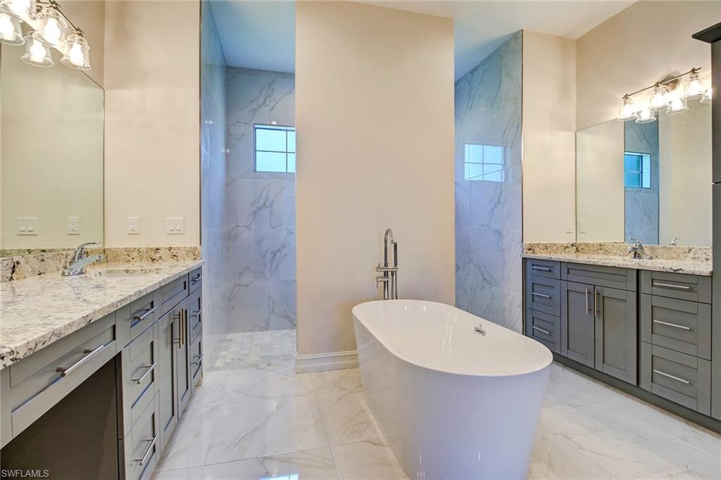 873 18th Street Northeast Naples, FL 34120 - Photo 11 of 18 a bathroom with a granite countertop sink and a mirror