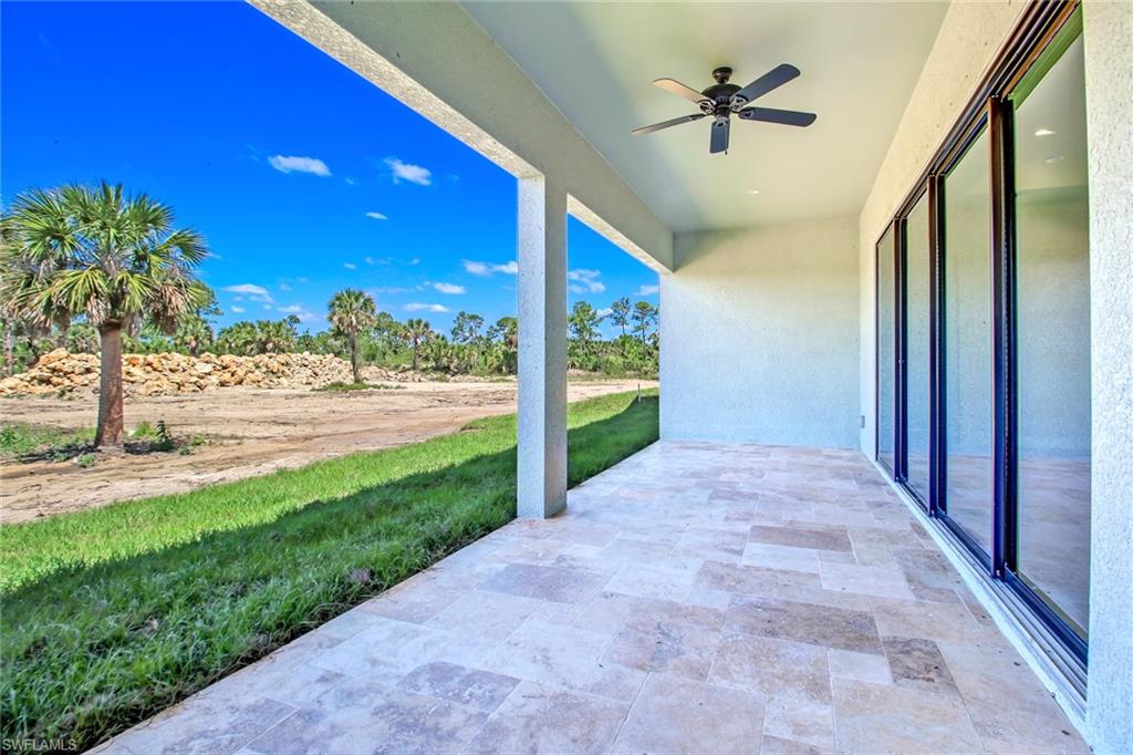 873 18th Street Northeast Naples, FL 34120 - Photo 17 of 18 a view of a porch and a yard