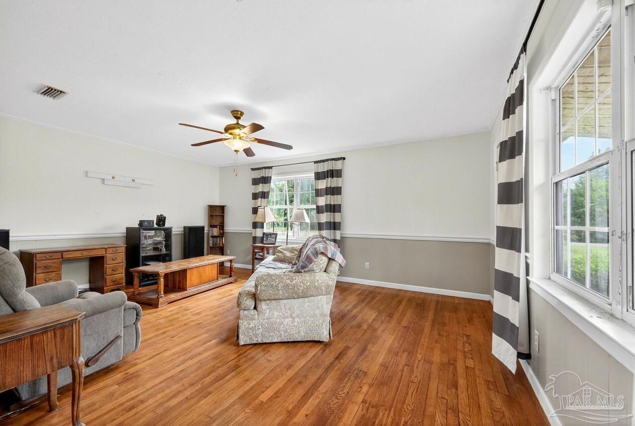 6253 Allentown Road Milton, FL 32570 - Photo 18 of 31 a living room with furniture and a fireplace