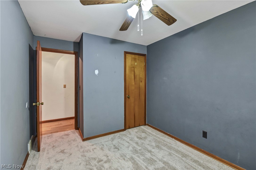 301 Crosse Road Amherst, OH 44001 - Photo 32 of 49 Carpeted room with a wooden ceiling fan and light fixture