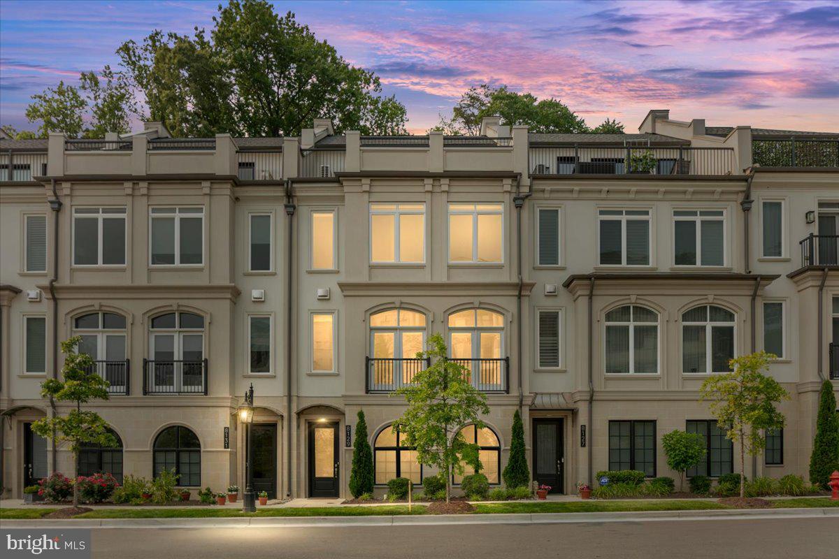 8129 River Road Bethesda, MD 20817 - Photo 2 of 84 a front view of a residential apartment building with a yard