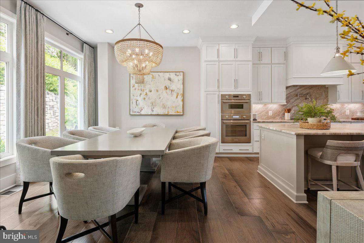 8129 River Road Bethesda, MD 20817 - Photo 21 of 84 a view of a dining room with furniture window and wooden floor