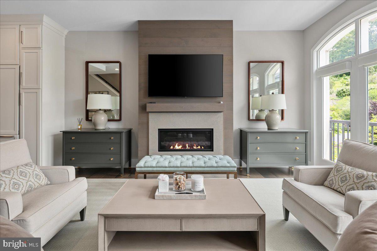 8129 River Road Bethesda, MD 20817 - Photo 23 of 84 a living room with furniture and a fireplace