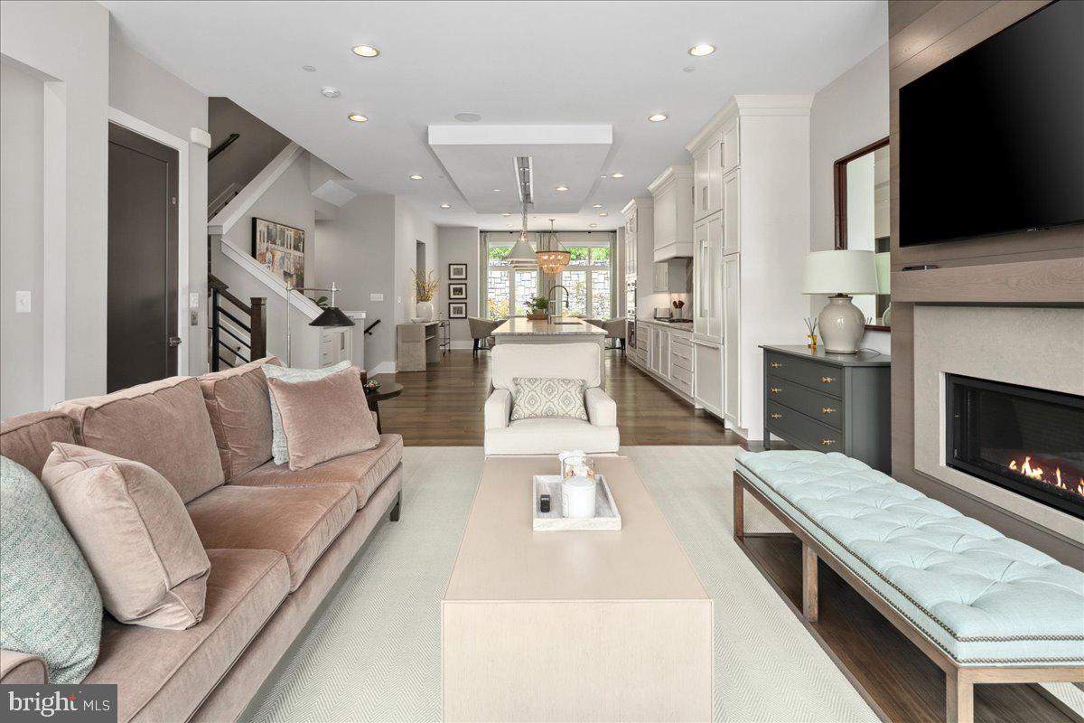 8129 River Road Bethesda, MD 20817 - Photo 24 of 84 a living room with furniture fireplace and flat screen tv