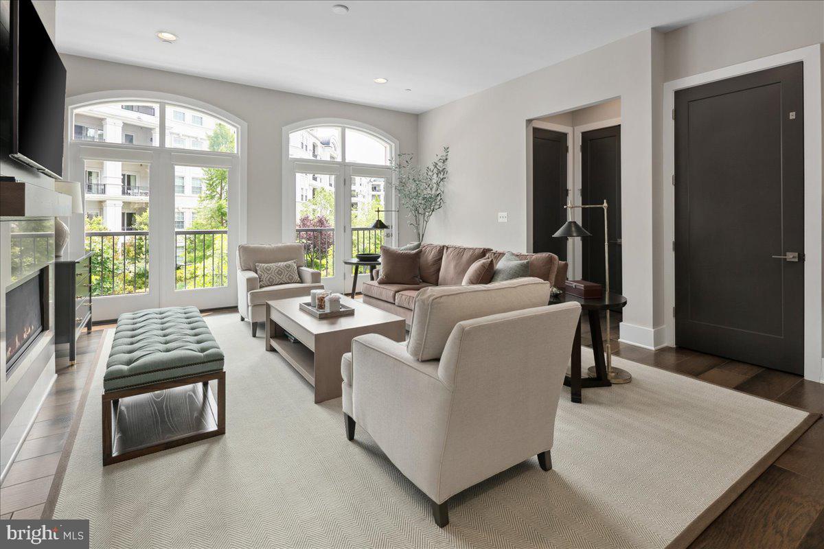 8129 River Road Bethesda, MD 20817 - Photo 26 of 84 a living room with furniture fireplace and a flat screen tv