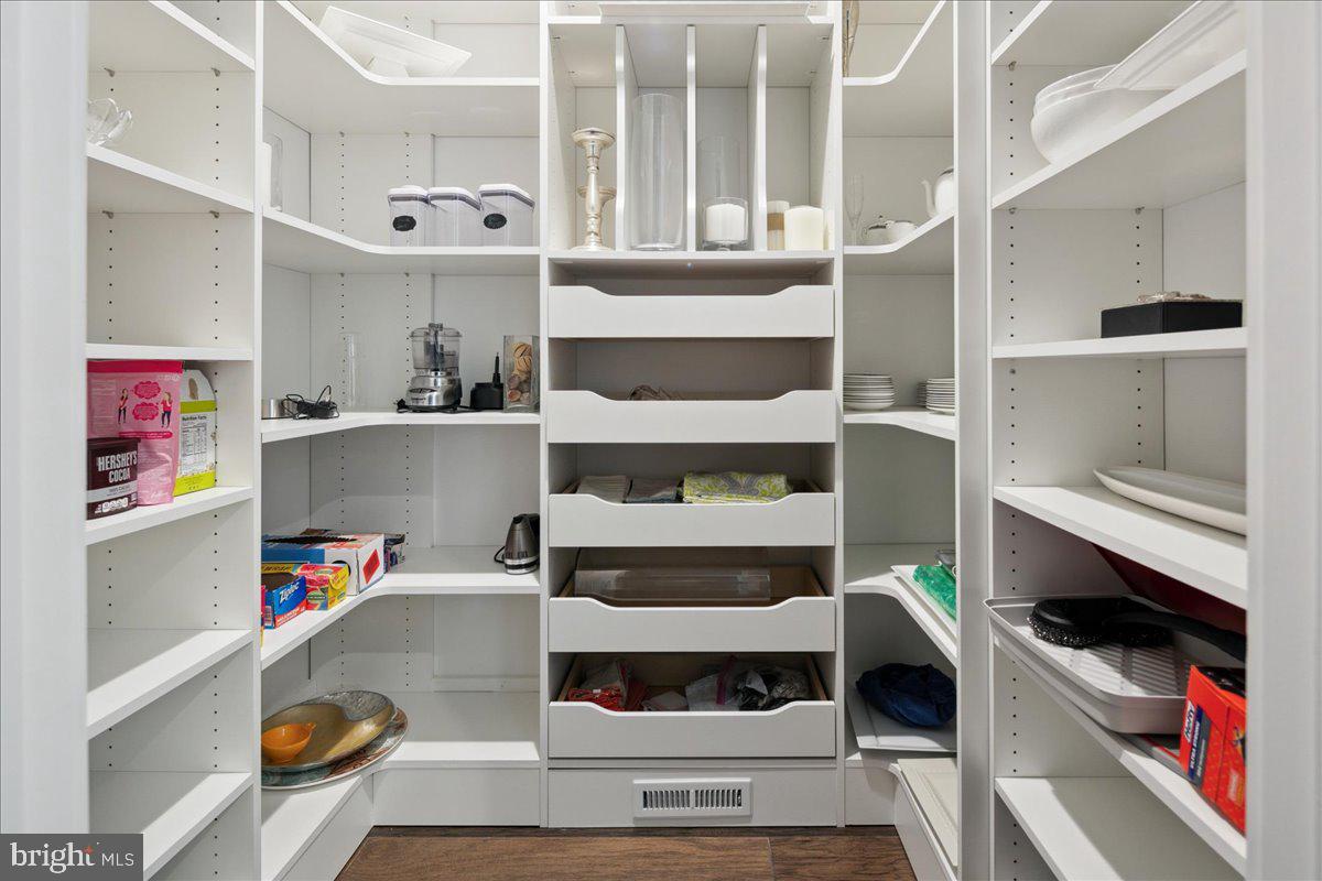 8129 River Road Bethesda, MD 20817 - Photo 29 of 84 a view of walk in closet with clothes and shoes