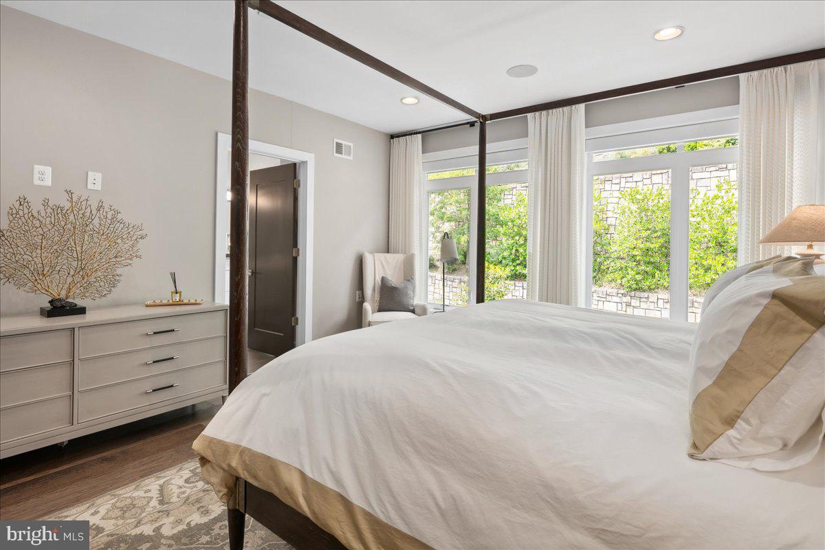 8129 River Road Bethesda, MD 20817 - Photo 34 of 84 a spacious bedroom with a large bed and a large window