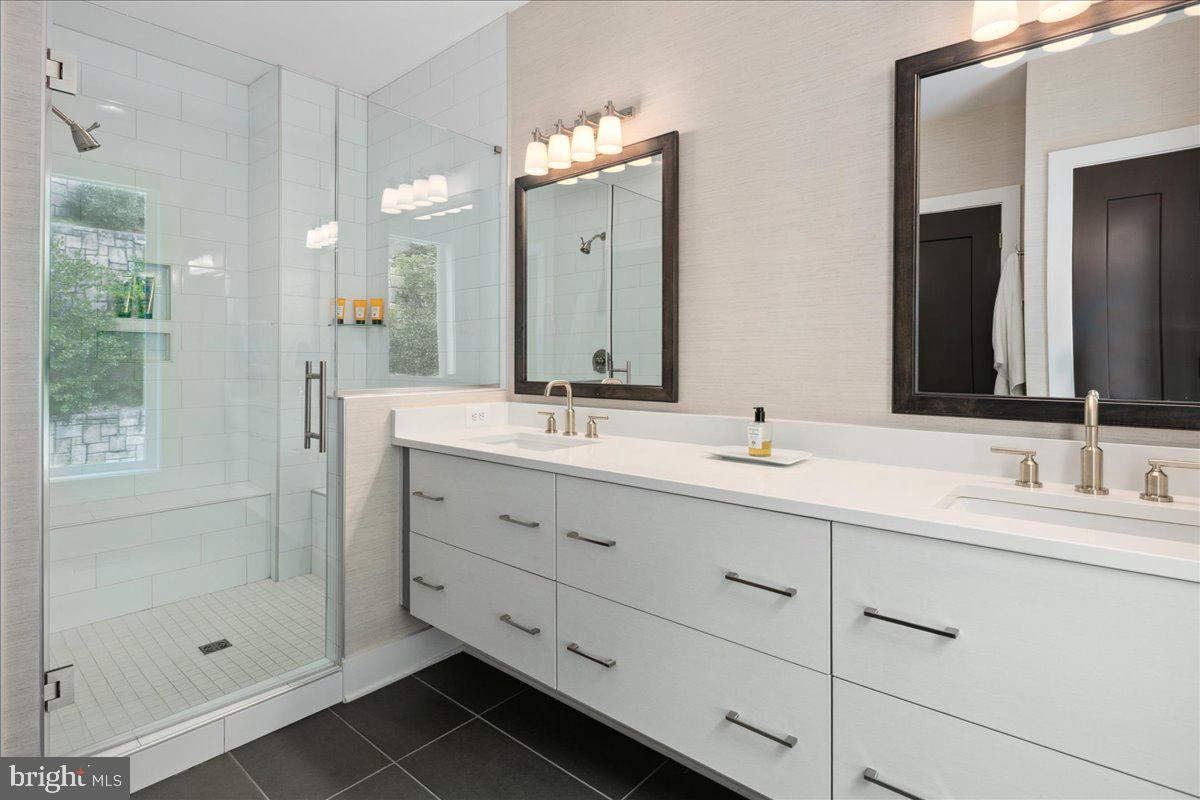 8129 River Road Bethesda, MD 20817 - Photo 37 of 84 a bathroom with double sink and a mirror