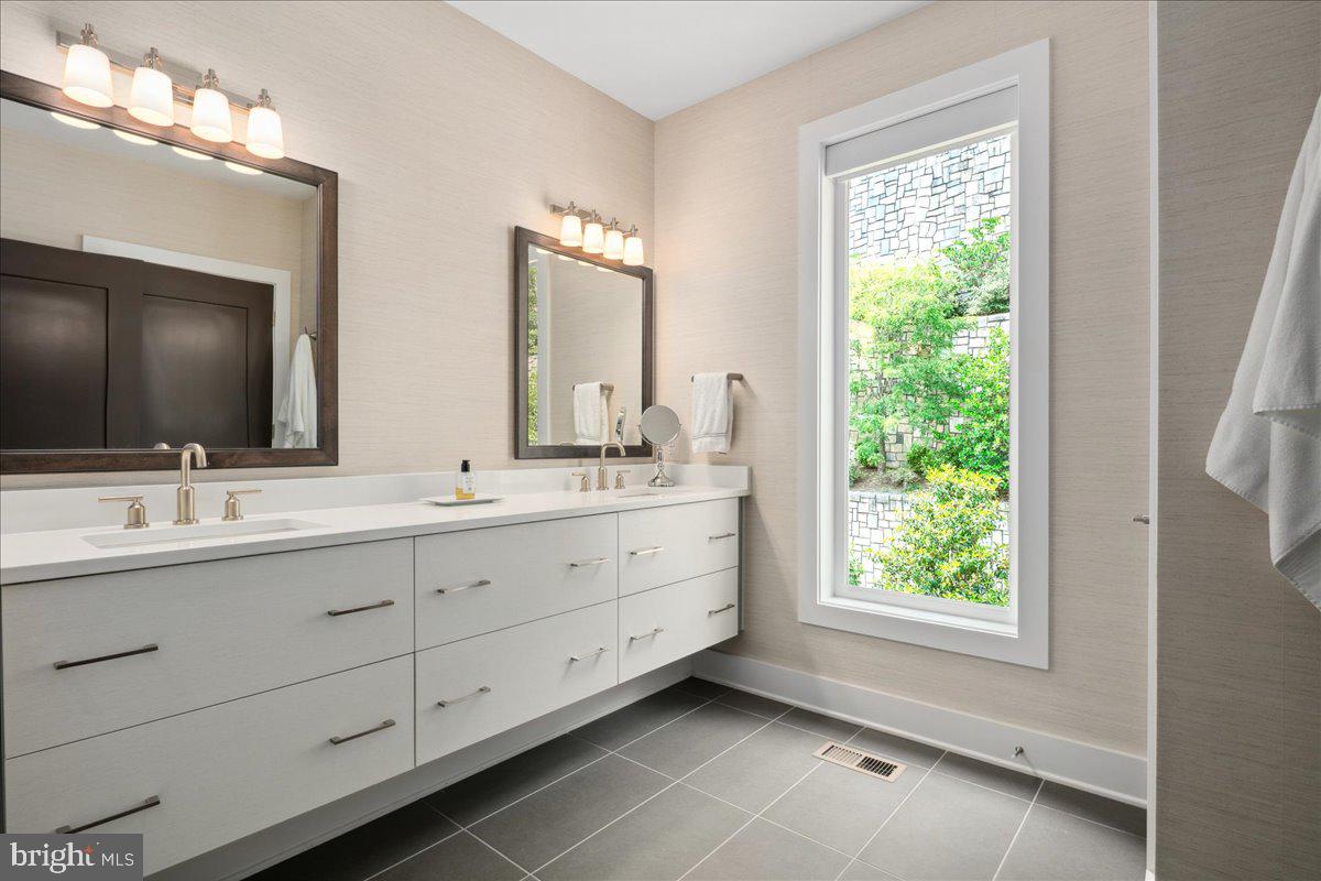 8129 River Road Bethesda, MD 20817 - Photo 38 of 84 a bathroom with double sink and a mirror
