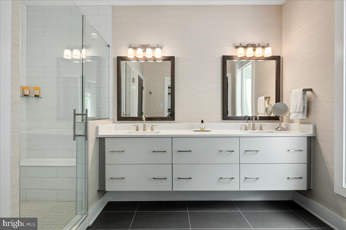 8129 River Road Bethesda, MD 20817 - Photo 39 of 84 a bathroom with double vanity and a mirror