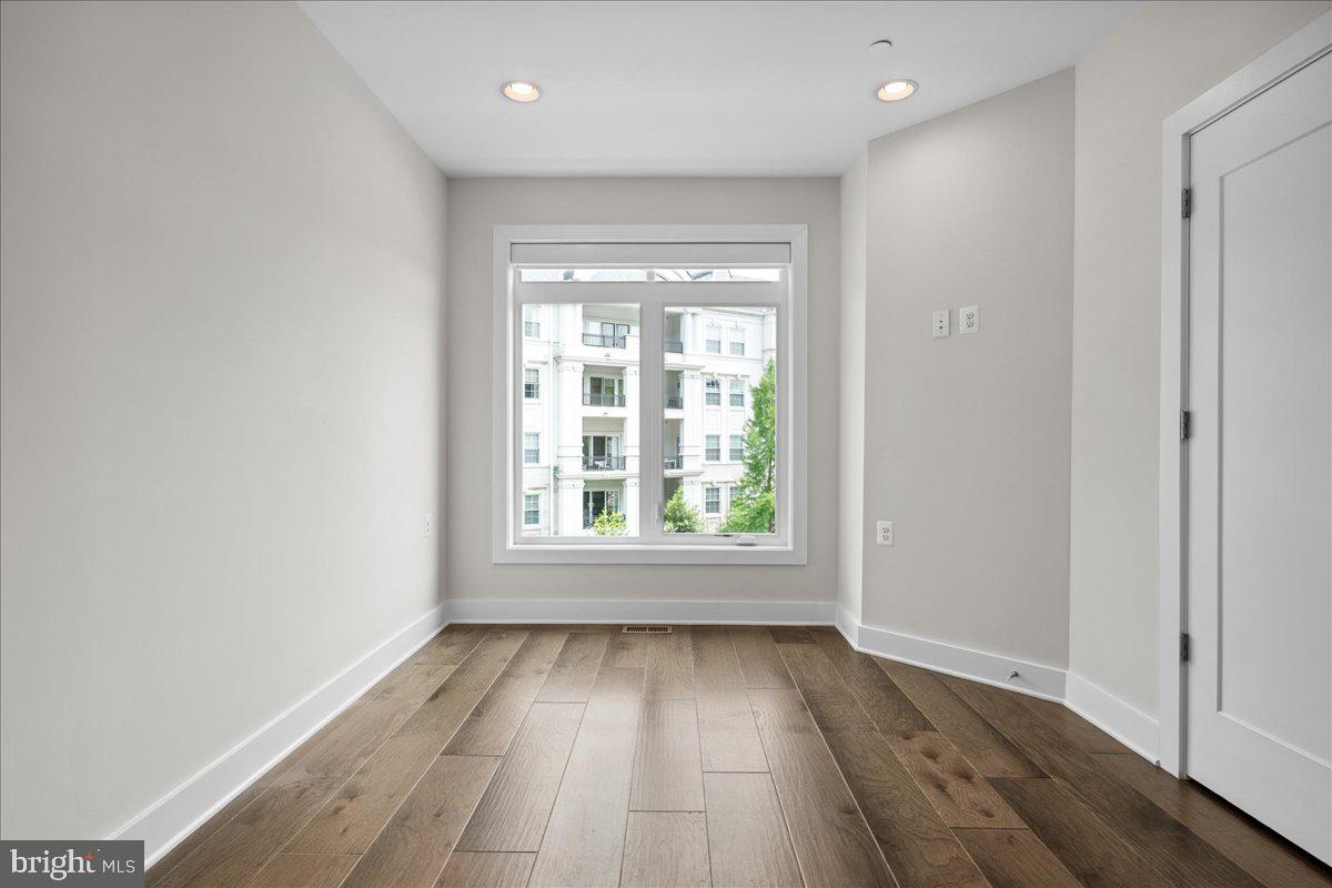 8129 River Road Bethesda, MD 20817 - Photo 43 of 84 an empty room with wooden floor and windows