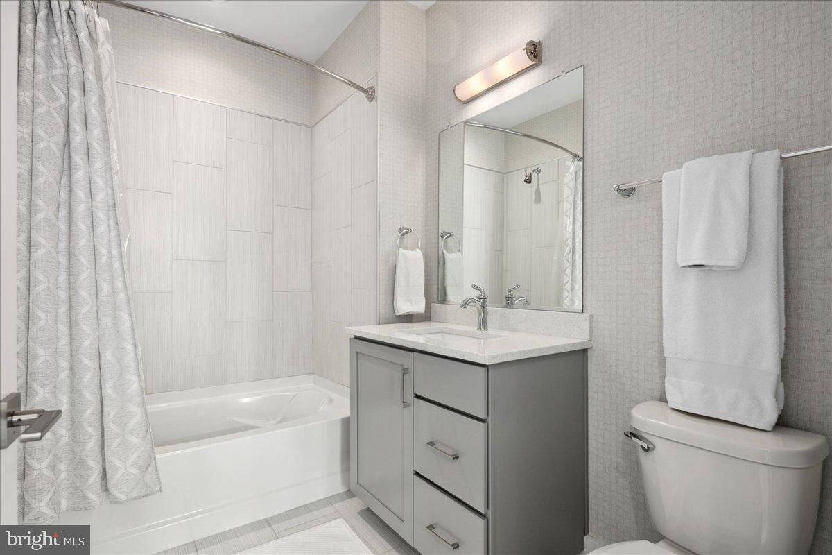 8129 River Road Bethesda, MD 20817 - Photo 45 of 84 a bathroom with a granite countertop sink toilet and shower