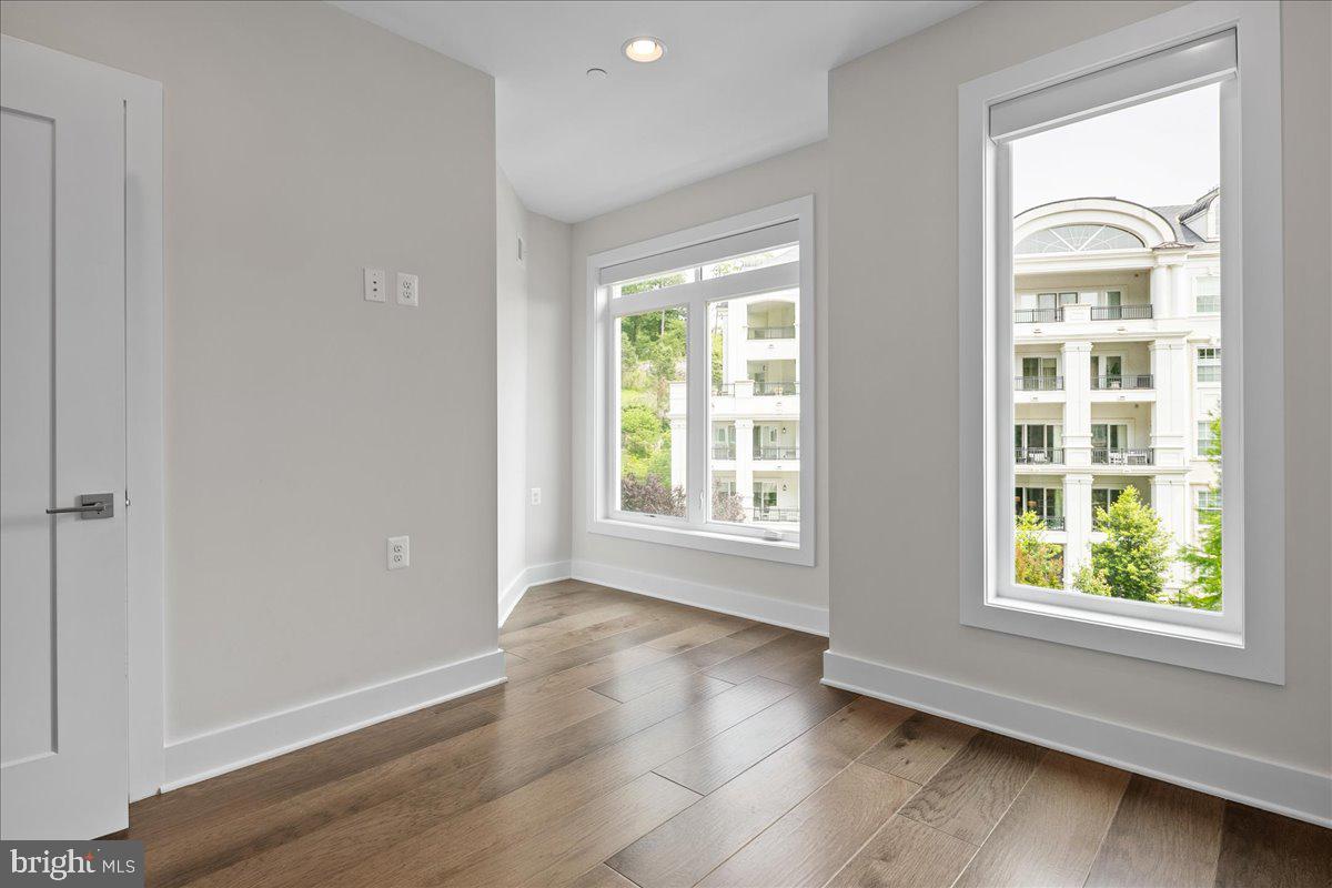 8129 River Road Bethesda, MD 20817 - Photo 47 of 84 an empty room with wooden floor and windows
