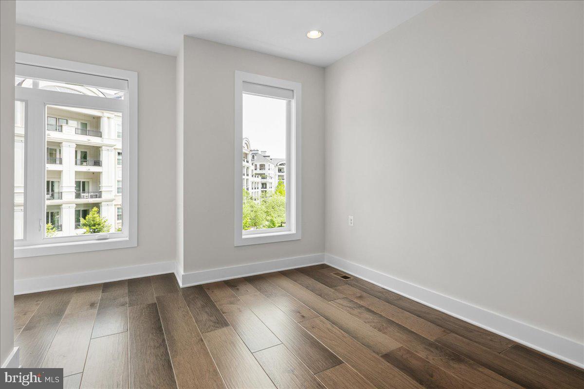 8129 River Road Bethesda, MD 20817 - Photo 48 of 84 an empty room with wooden floor and windows