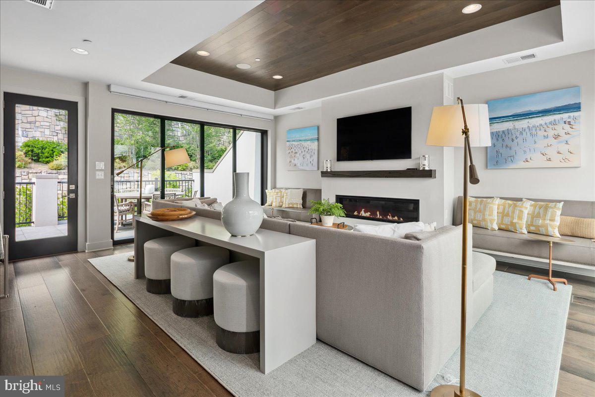 8129 River Road Bethesda, MD 20817 - Photo 49 of 84 a living room with kitchen island furniture and a flat screen tv