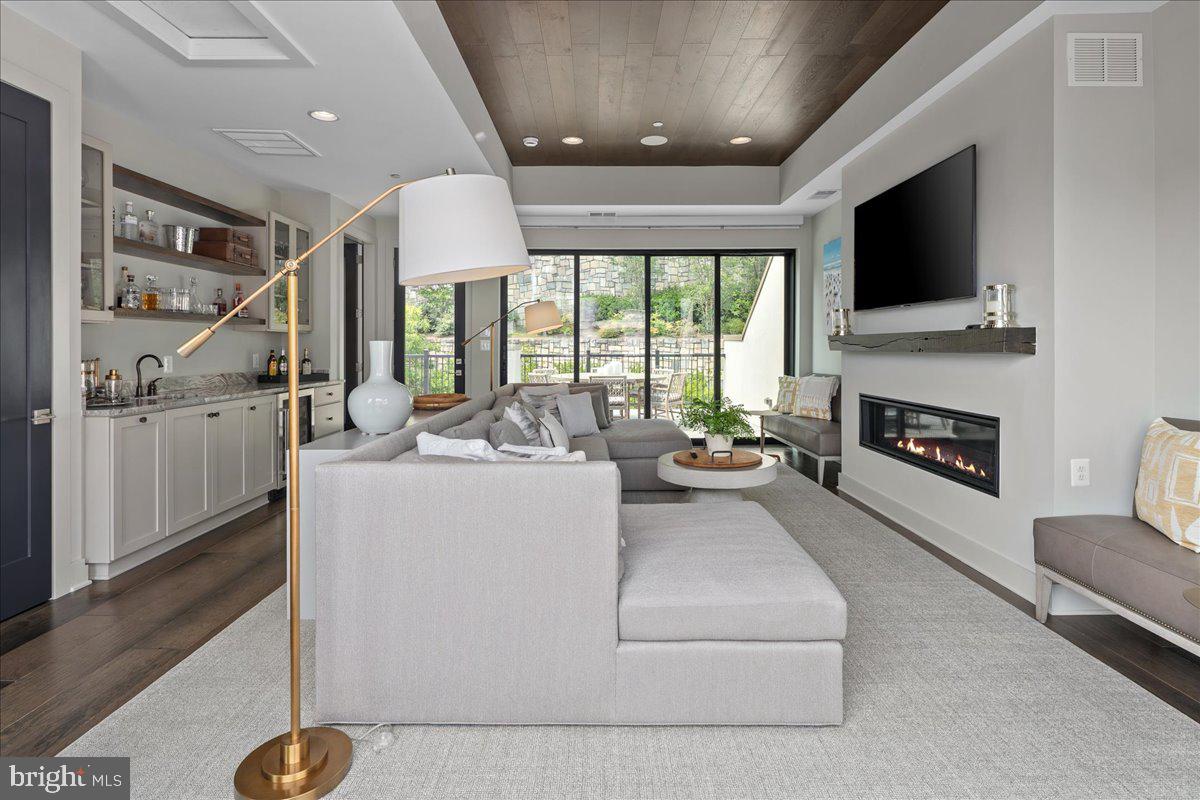 8129 River Road Bethesda, MD 20817 - Photo 53 of 84 a living room with furniture and a flat screen tv