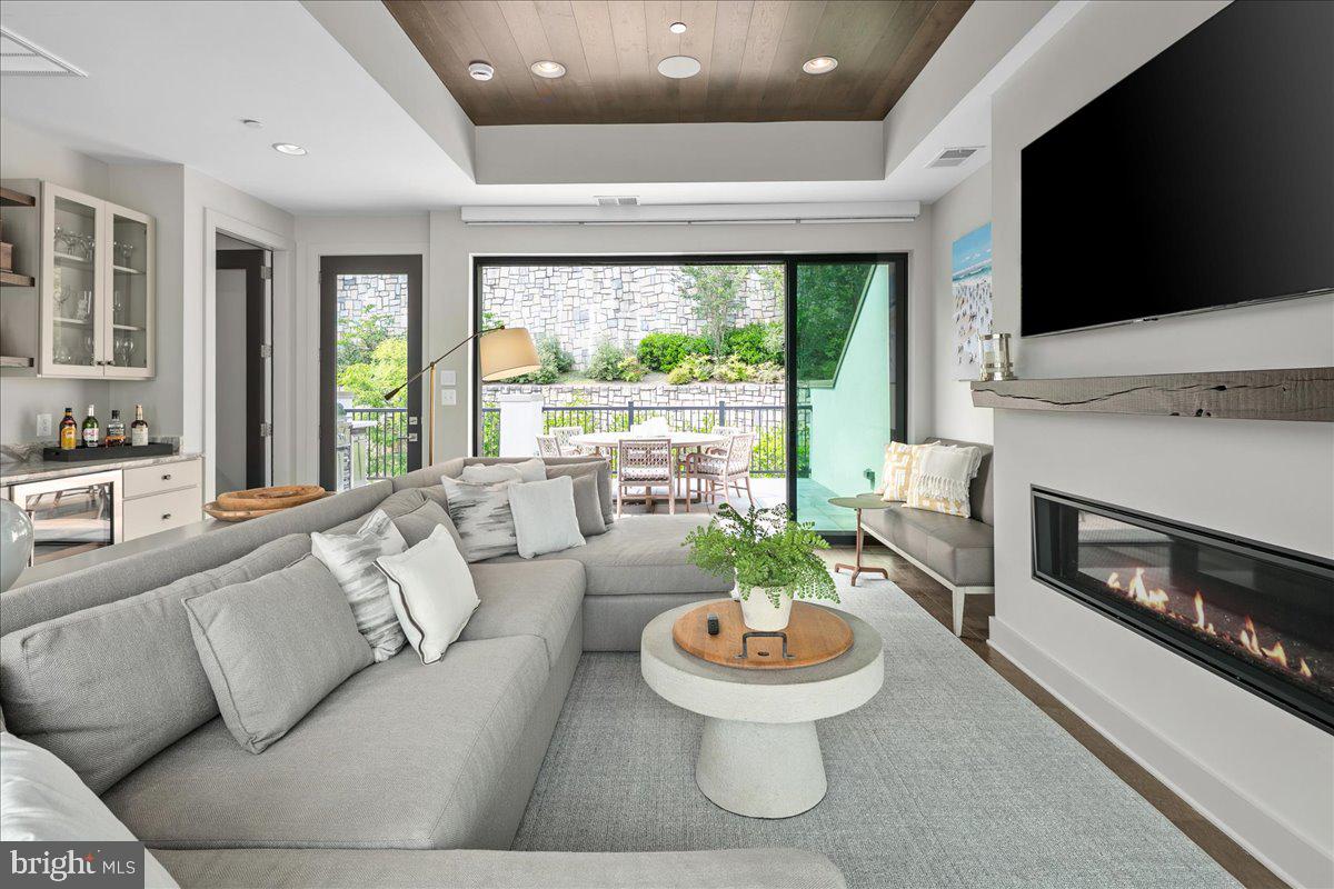 8129 River Road Bethesda, MD 20817 - Photo 54 of 84 a living room with furniture and a fireplace